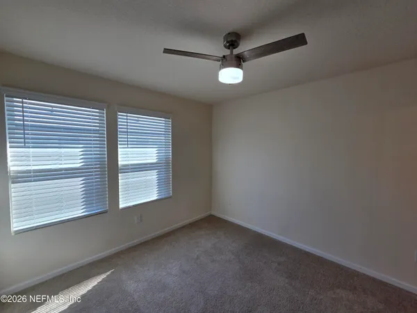 a view of a hallway to rooms