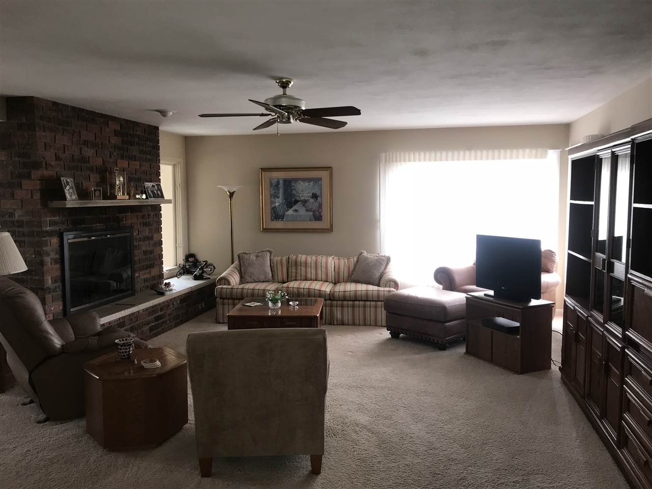 720 Roxbury Road Rockford, IL 61107 - Photo 3 of 18 a living room with furniture a fireplace and a flat screen tv
