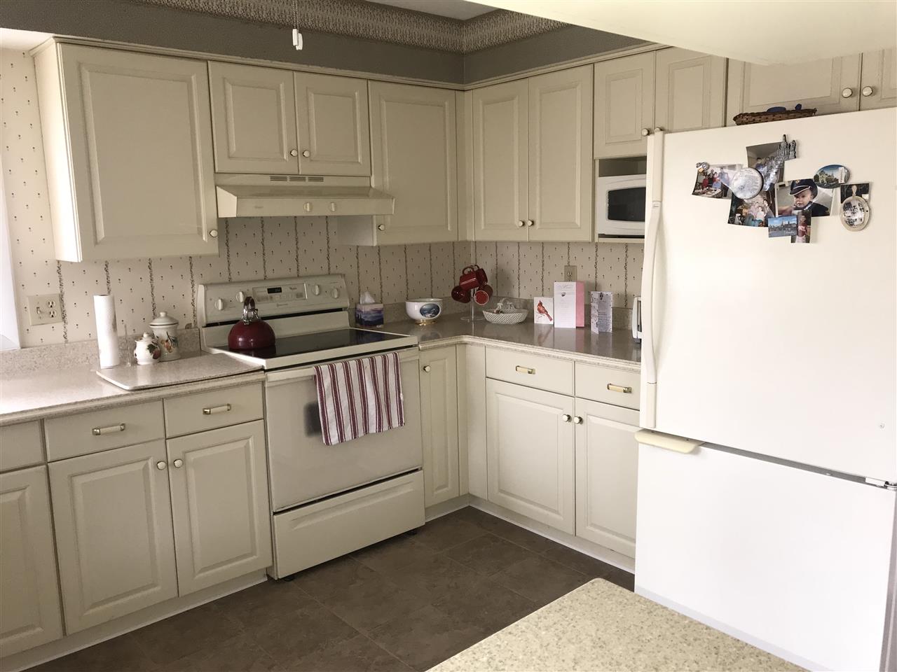 720 Roxbury Road Rockford, IL 61107 - Photo 7 of 18 a kitchen with white cabinets and white appliances