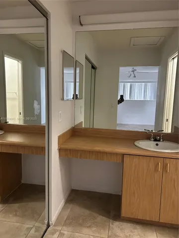 a spacious bathroom with a tub a mirror and vanity