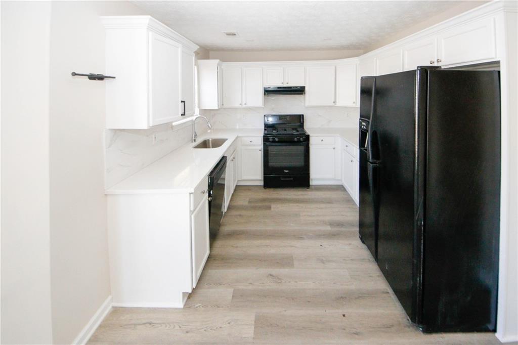 4493 Bridle Ridge Way Lithonia, GA 30038 - Photo 11 of 35 a kitchen with a refrigerator and a sink