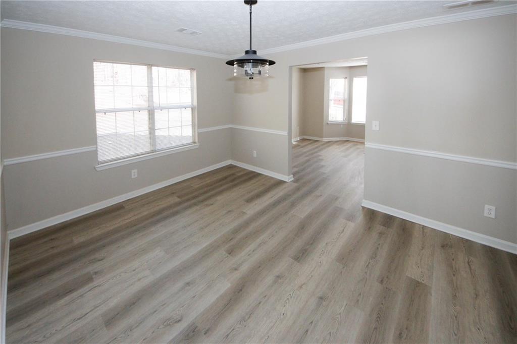 4493 Bridle Ridge Way Lithonia, GA 30038 - Photo 15 of 35 an empty room with wooden floor windows and entrance
