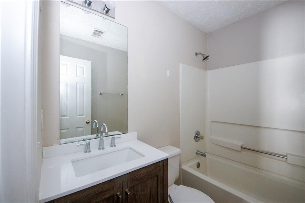 4493 Bridle Ridge Way Lithonia, GA 30038 - Photo 30 of 35 a bathroom with a sink a toilet and shower