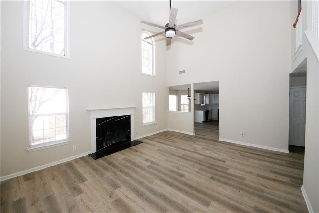 4493 Bridle Ridge Way Lithonia, GA 30038 - Photo 6 of 35 a view of empty room with a fireplace and wooden floor