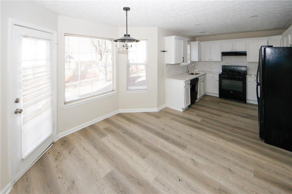 4493 Bridle Ridge Way Lithonia, GA 30038 - Photo 9 of 35 a view of a kitchen with a stove cabinets and wooden floor
