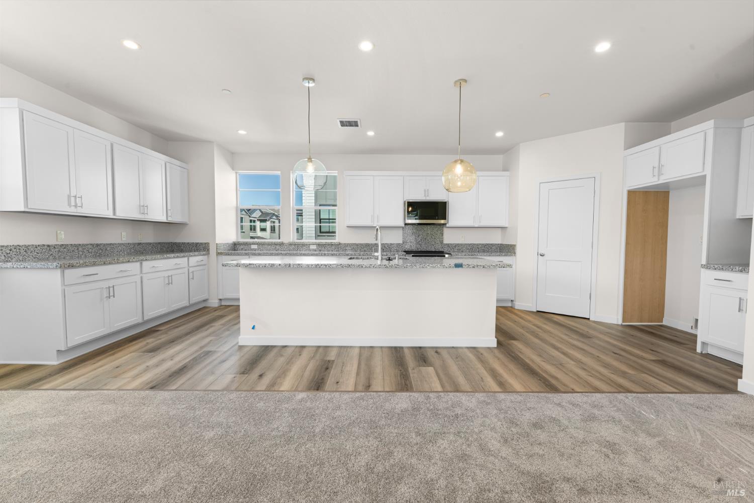 1448 Waterside Lane Rohnert Park, CA 94928 - Photo 2 of 35 a large kitchen with kitchen island a stove a sink a center island and cabinets