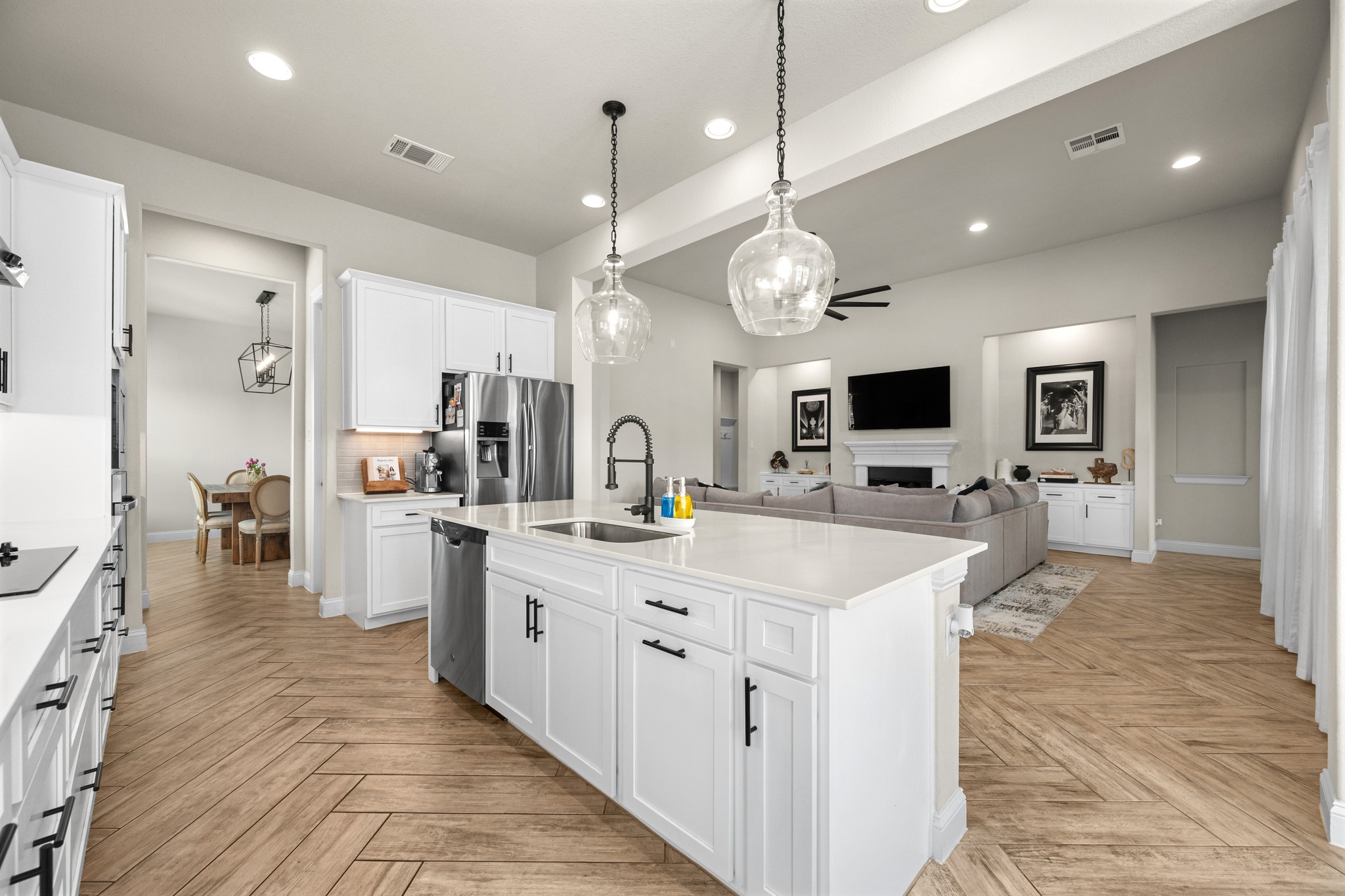 2100 Highland Ridge Road Georgetown, TX 78628 - Photo 14 of 30 An open concept design seamlessly connects the sleek, well-lit kitchen with a comfortable living space.