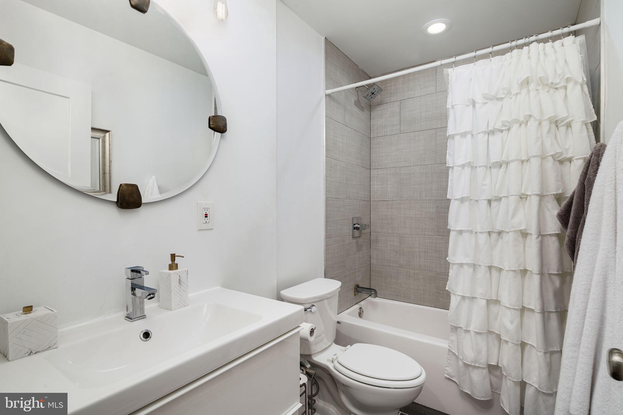2711 West Jefferson Street, Unit 2 Philadelphia, PA 19121 - Photo 11 of 27 a bathroom with a sink a toilet and shower