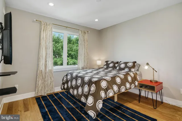 a bedroom with a bed and wooden floor