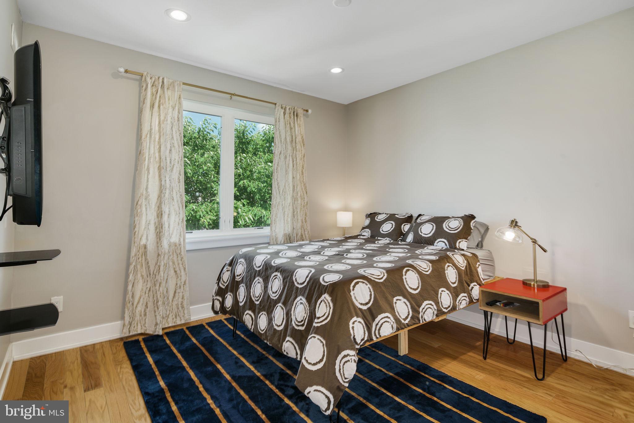 2711 West Jefferson Street, Unit 2 Philadelphia, PA 19121 - Photo 17 of 27 a bedroom with a bed and wooden floor