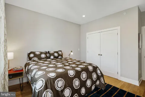 a bedroom with a bed and a painting on the wall