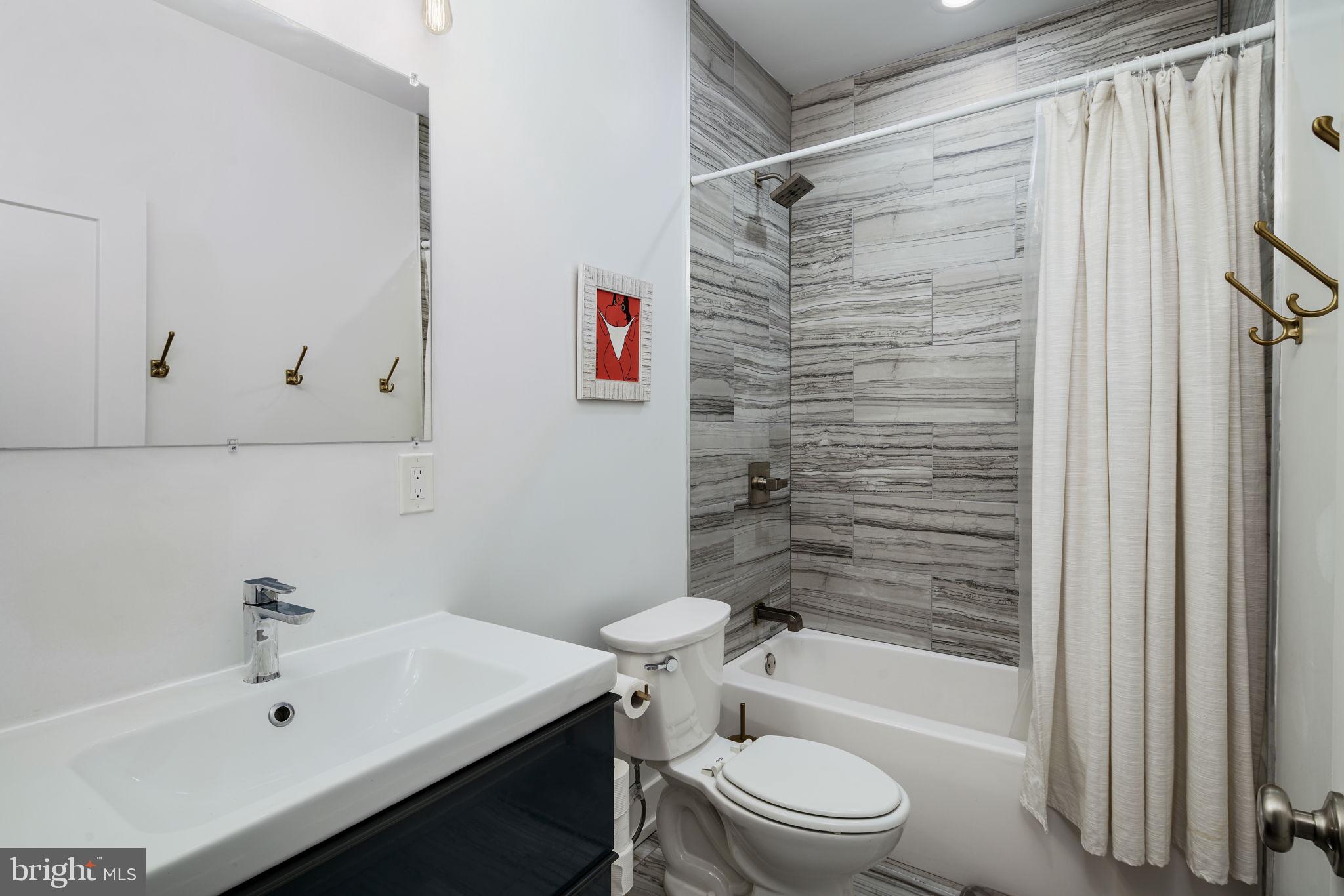 2711 West Jefferson Street, Unit 2 Philadelphia, PA 19121 - Photo 21 of 27 a bathroom with a sink a toilet and shower