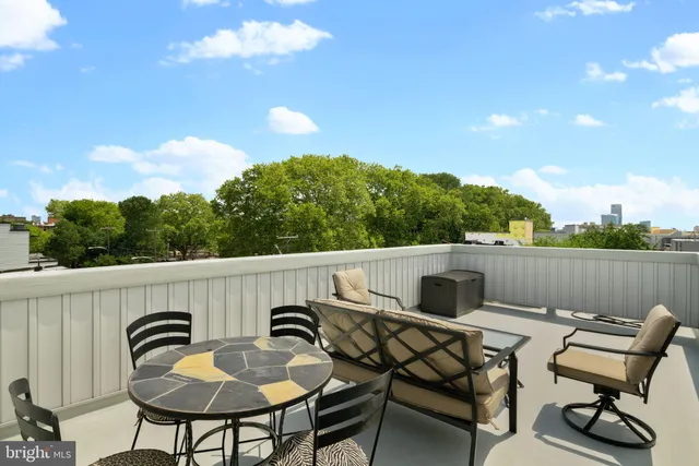 a terrace of a house with table and chairs