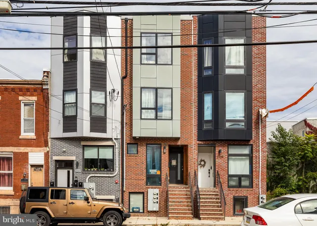 a couple of cars parked in front of a building