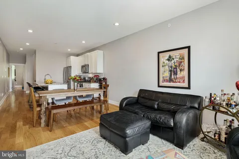 a living room with furniture and kitchen view