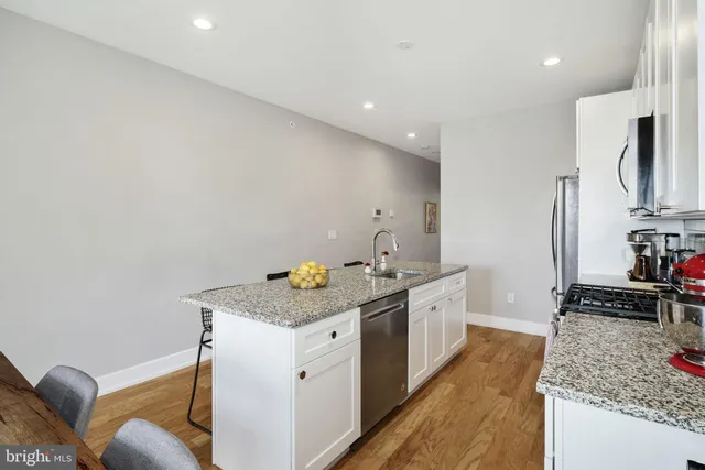 a kitchen with a sink stove and refrigerator