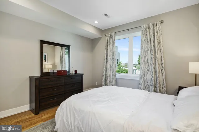 a bedroom with a bed and a mirror