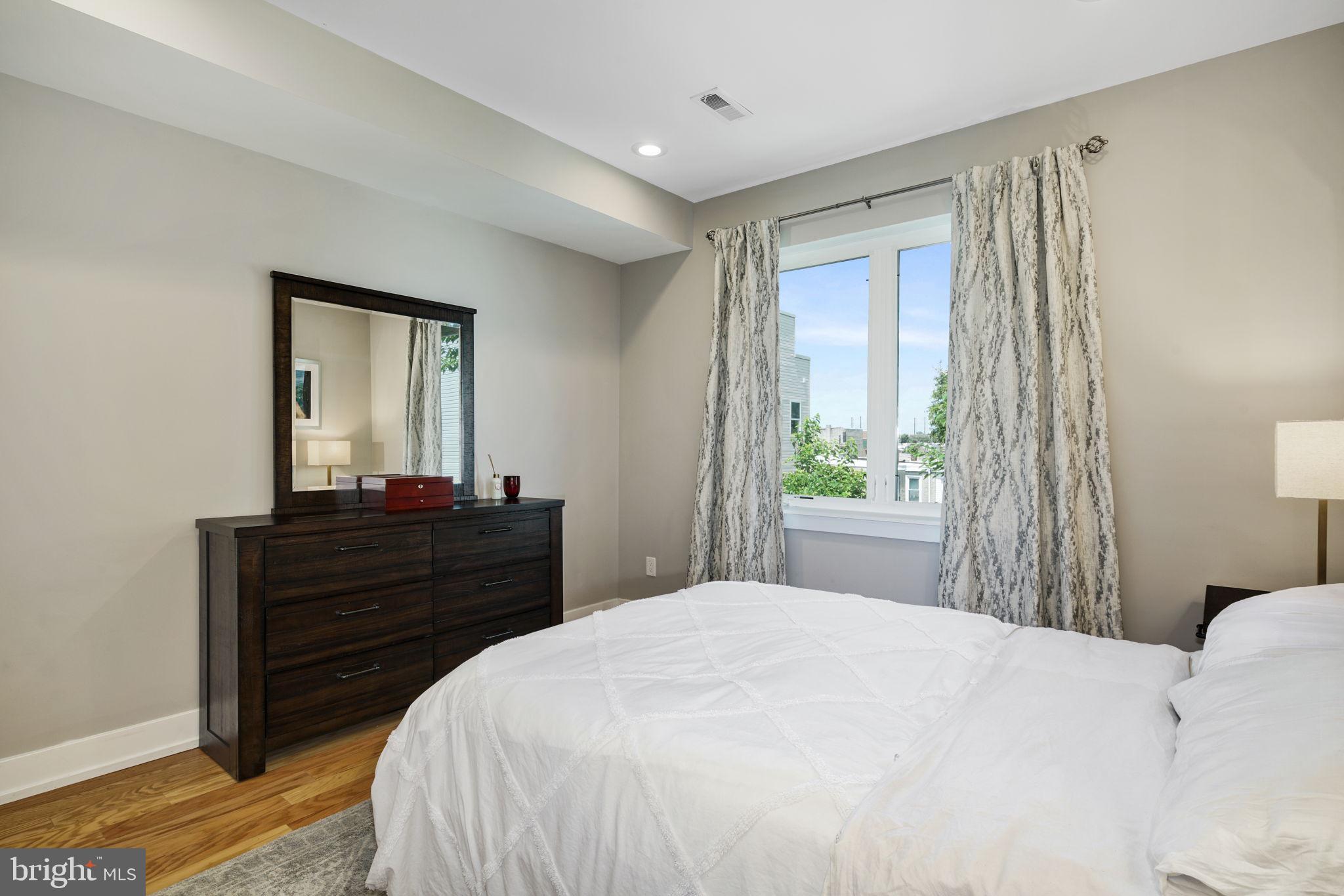 2711 West Jefferson Street, Unit 2 Philadelphia, PA 19121 - Photo 8 of 27 a bedroom with a bed and a mirror