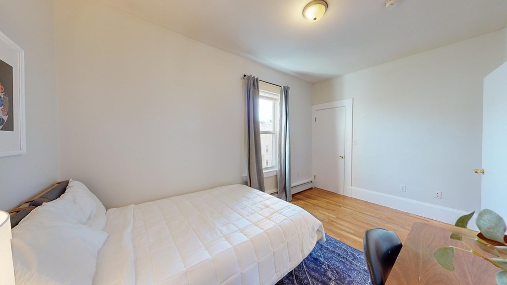 11 Elder Street, Unit 3 Boston, MA 02125 - Photo 11 of 26 a bedroom with a bed and a window