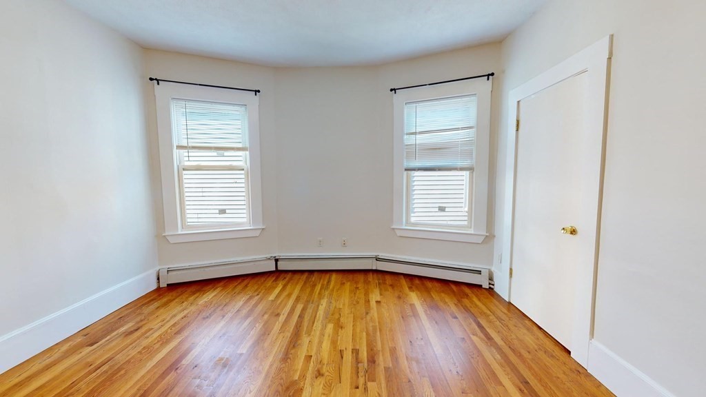 11 Elder Street, Unit 3 Boston, MA 02125 - Photo 14 of 26 a view of empty room with wooden floor and fan