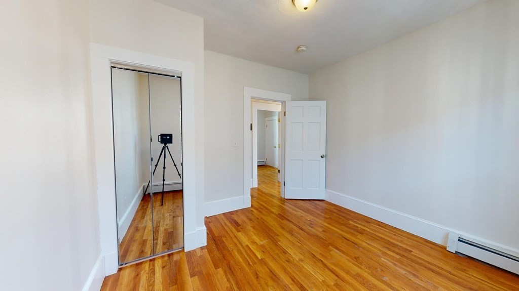 11 Elder Street, Unit 3 Boston, MA 02125 - Photo 16 of 26 a view of empty room with wooden floor