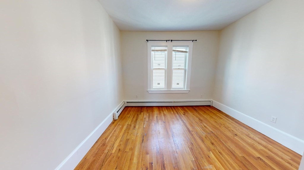11 Elder Street, Unit 3 Boston, MA 02125 - Photo 20 of 26 a view of a room with wooden floor and window