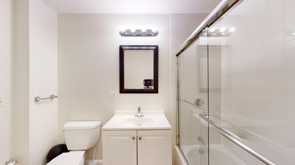 11 Elder Street, Unit 3 Boston, MA 02125 - Photo 24 of 26 a bathroom with a toilet a sink and mirror