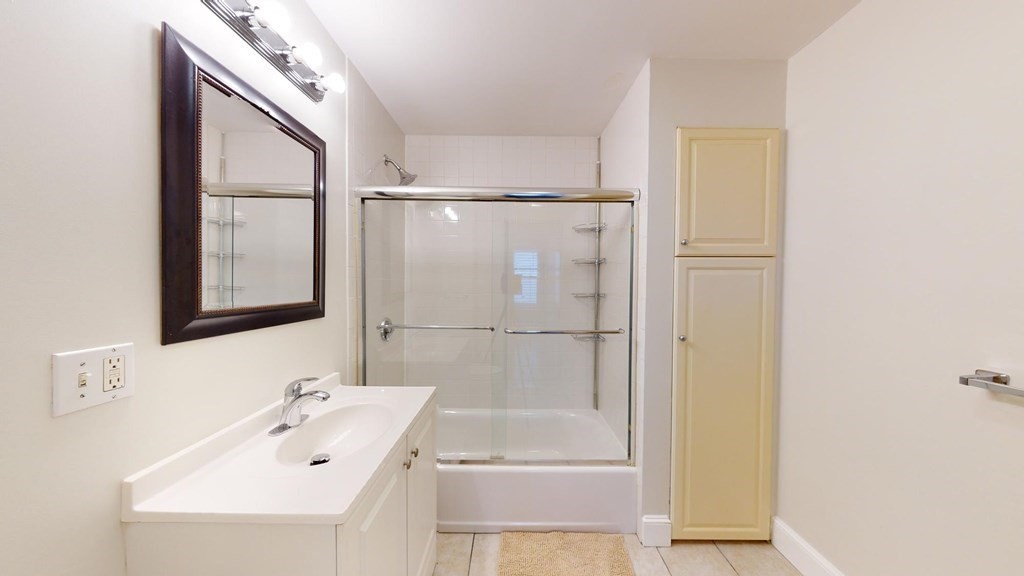 11 Elder Street, Unit 3 Boston, MA 02125 - Photo 25 of 26 a bathroom with a tub a sink and mirror