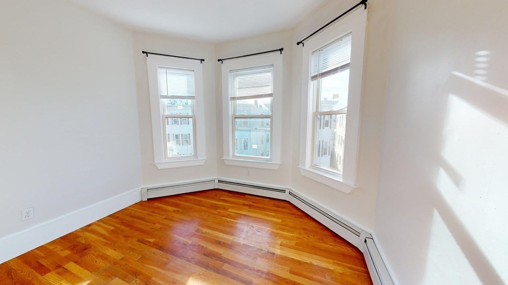 11 Elder Street, Unit 3 Boston, MA 02125 - Photo 5 of 26 a view of empty room with window