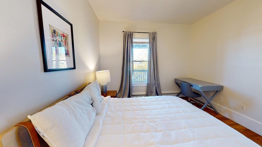 11 Elder Street, Unit 3 Boston, MA 02125 - Photo 8 of 26 a bedroom with a bed and a painting on the wall