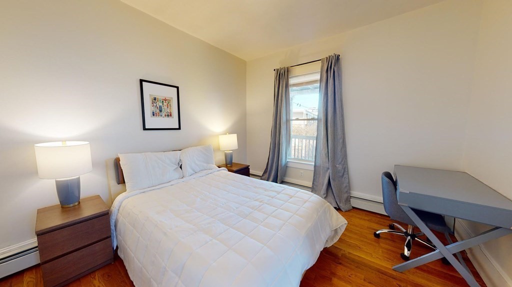 11 Elder Street, Unit 3 Boston, MA 02125 - Photo 10 of 26 a bedroom with a bed and a window