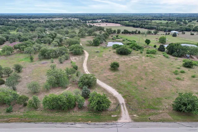 an aerial view of a house with a yard