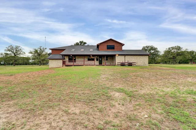 a front view of house with yard and trees