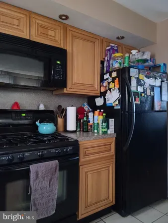 a kitchen with stainless steel appliances granite countertop a stove and cabinets