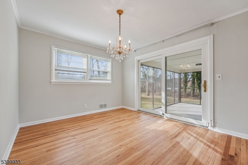 35 South Derby Road Springfield, NJ 07081 - Photo 11 of 30 a view of an empty room with wooden floor and windows