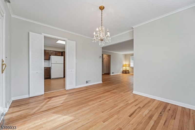 35 South Derby Road Springfield, NJ 07081 - Photo 13 of 30 a view of livingroom with chandelier and wooden floor