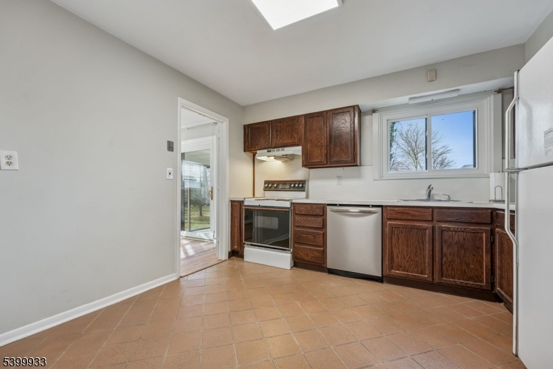 35 South Derby Road Springfield, NJ 07081 - Photo 16 of 30 a large kitchen with stainless steel appliances granite countertop a stove and a sink