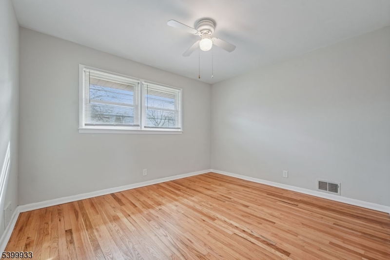 35 South Derby Road Springfield, NJ 07081 - Photo 18 of 30 a view of a room with wooden floor and a ceiling fan