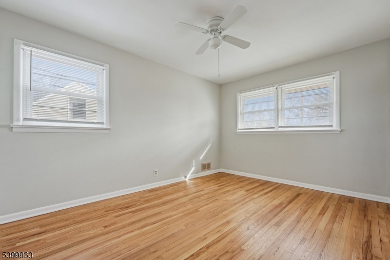 35 South Derby Road Springfield, NJ 07081 - Photo 19 of 30 a view of empty room with wooden floor and fan