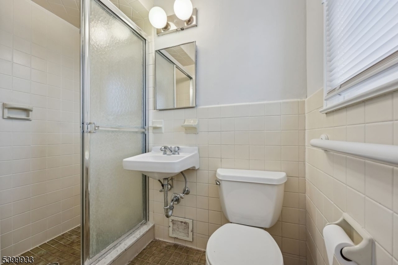 35 South Derby Road Springfield, NJ 07081 - Photo 23 of 30 a bathroom with a toilet sink and mirror