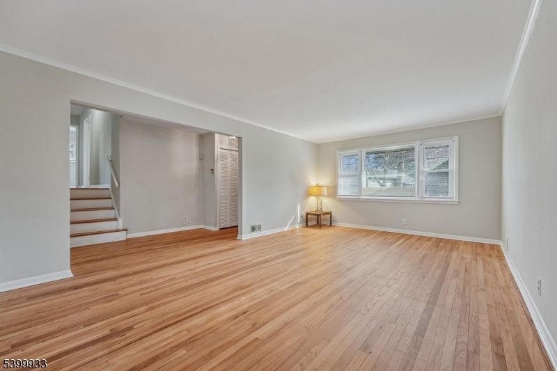 35 South Derby Road Springfield, NJ 07081 - Photo 6 of 30 a view of an empty room with wooden floor and a window