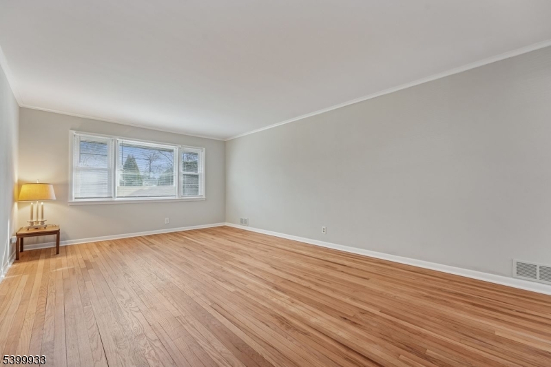 35 South Derby Road Springfield, NJ 07081 - Photo 7 of 30 an empty room with wooden floor and windows