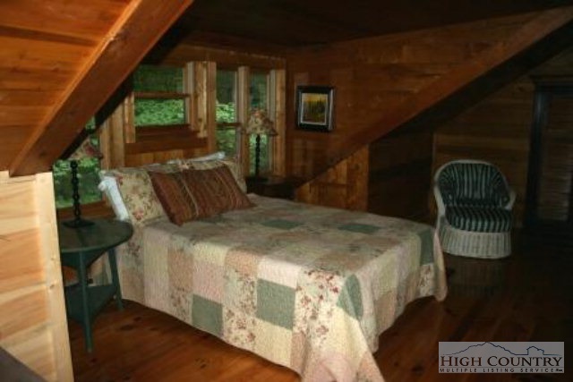 838 Norris Creek Road Boone, NC 28607 - Photo 3 of 10 a bed sitting in a bedroom next to a window