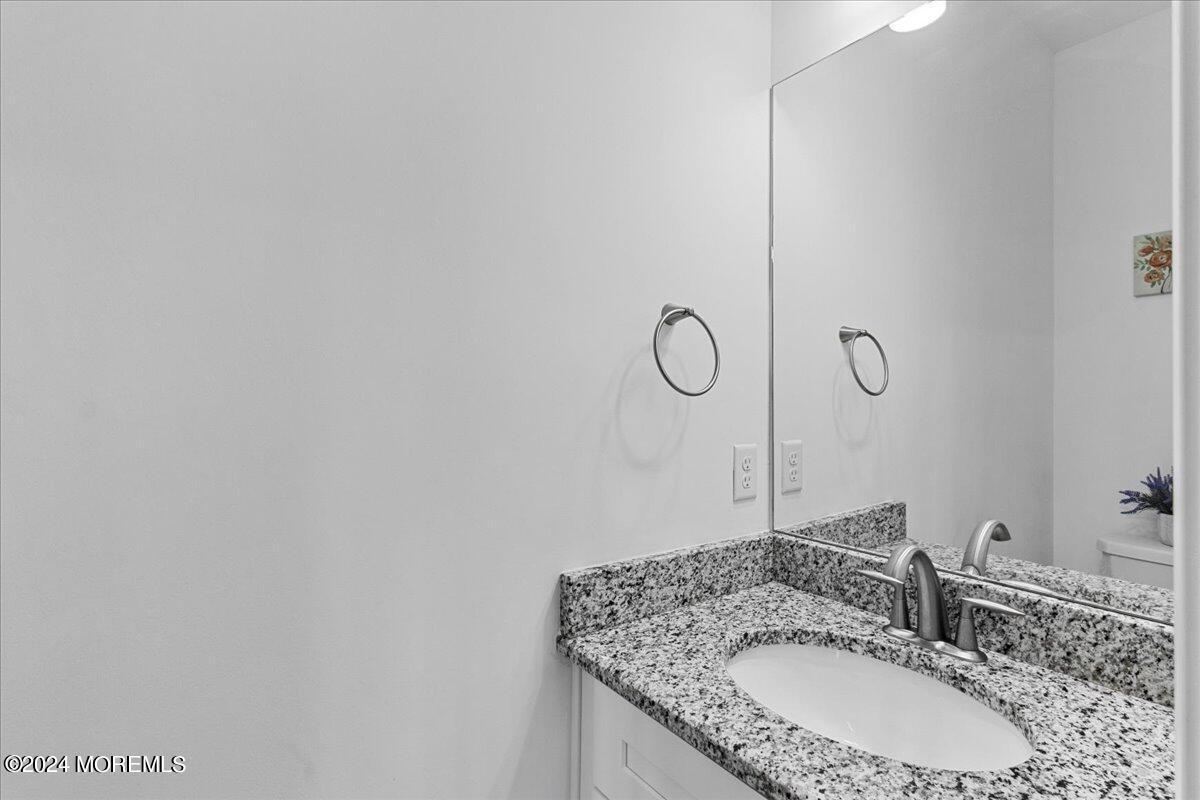 104 Prestige Road Brick, NJ 08723 - Photo 17 of 43 a bathroom with a granite countertop sink and a mirror