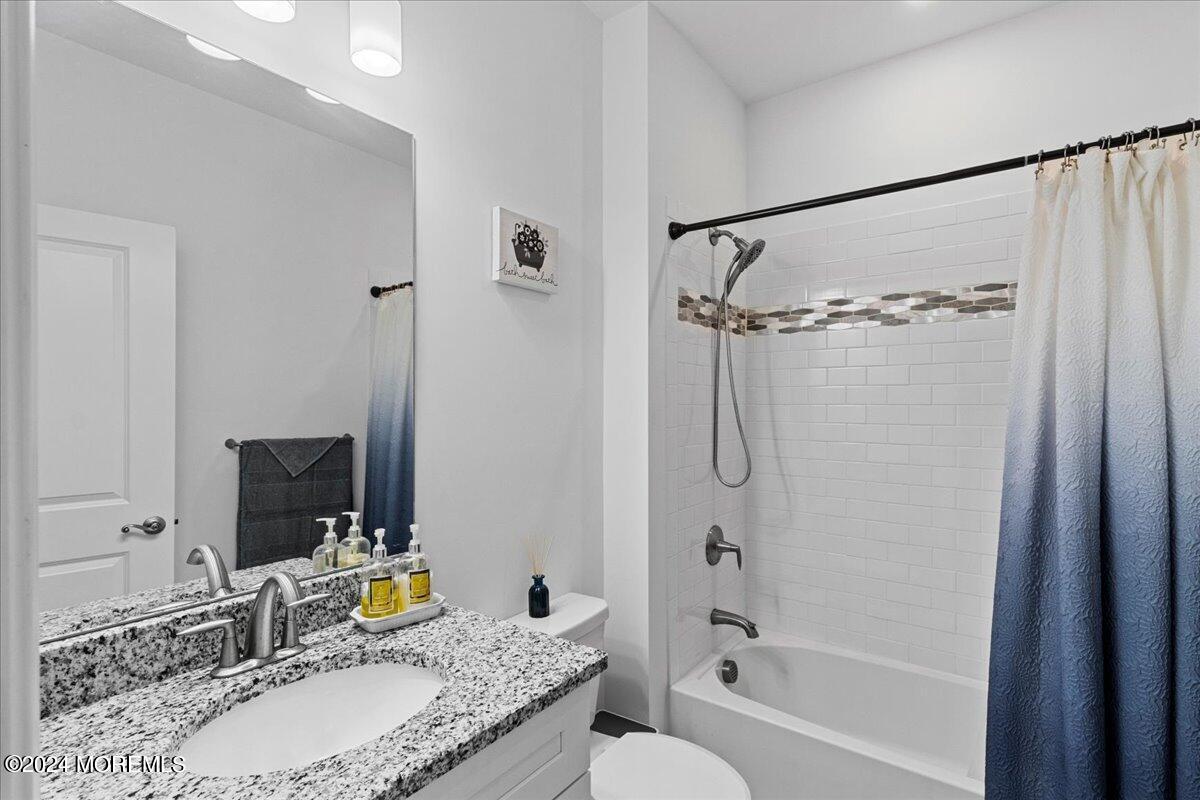 104 Prestige Road Brick, NJ 08723 - Photo 18 of 43 a bathroom with a granite countertop sink a toilet and shower