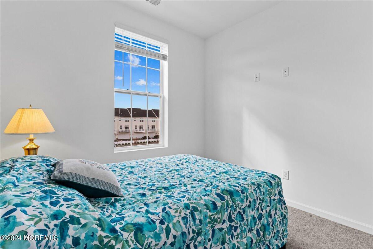 104 Prestige Road Brick, NJ 08723 - Photo 21 of 43 a bedroom with a bed and a lamp on dresser