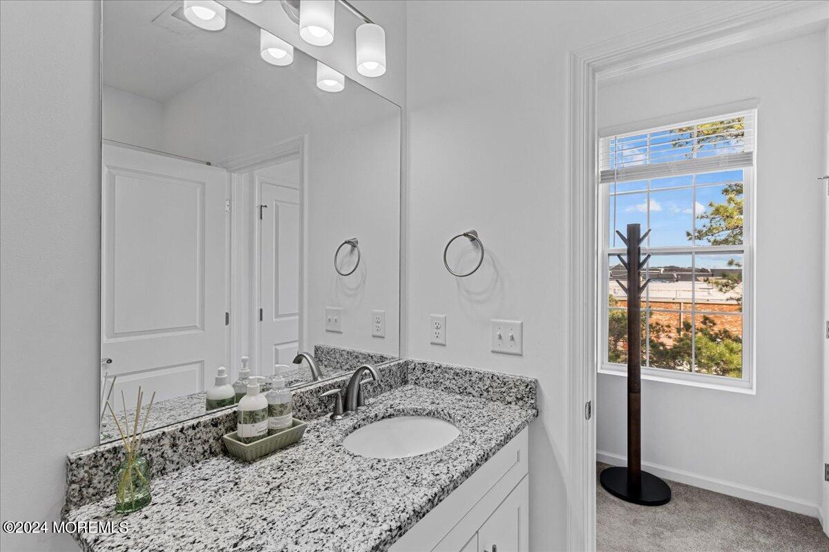 104 Prestige Road Brick, NJ 08723 - Photo 27 of 43 a bathroom with a granite countertop sink a mirror and shower