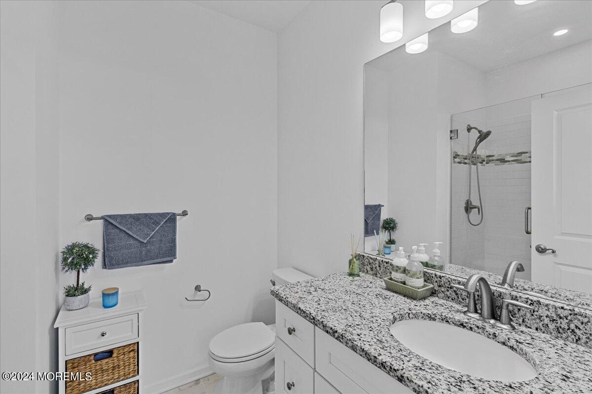 104 Prestige Road Brick, NJ 08723 - Photo 28 of 43 a bathroom with a granite countertop sink a toilet and a mirror