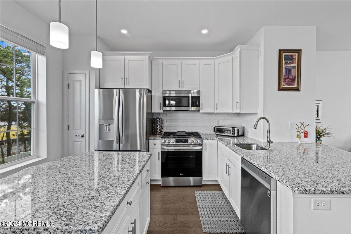104 Prestige Road Brick, NJ 08723 - Photo 3 of 43 a kitchen with stainless steel appliances granite countertop a sink stove and refrigerator