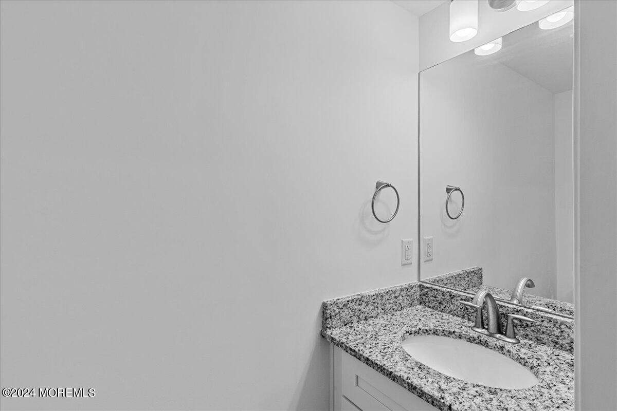 104 Prestige Road Brick, NJ 08723 - Photo 34 of 43 a bathroom with a granite countertop sink a mirror and vanity